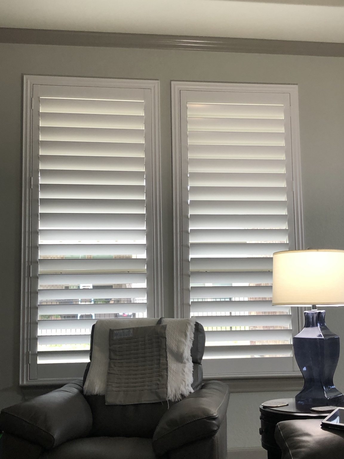 White plantation shutters installed in a living room